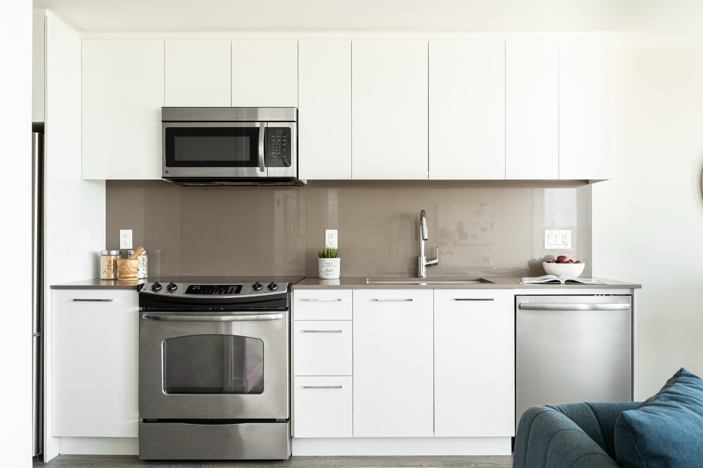 A kitchen at Aria with white cabinetry and stainless appliances
