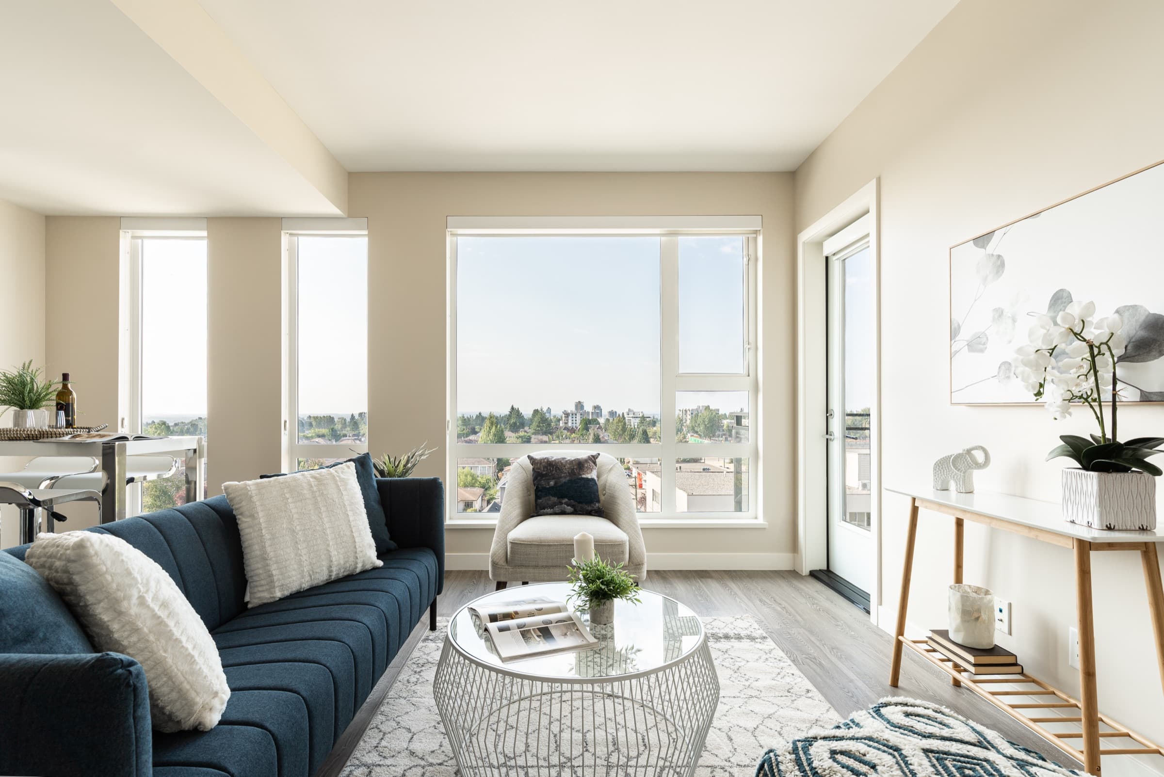 A furnished living room at Aria with the neighbourhood beyond the windows